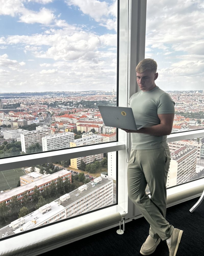 Louis Lanaway working on a laptop high above a city
